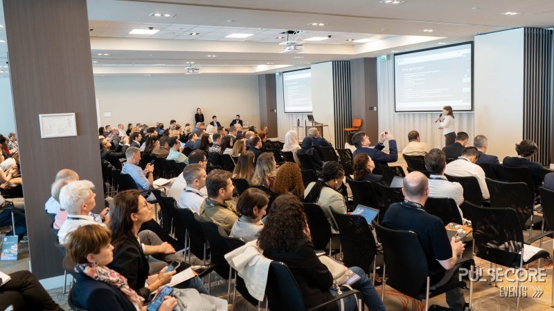 A wide view of a conference hall during a talk at a previous PulseCore event